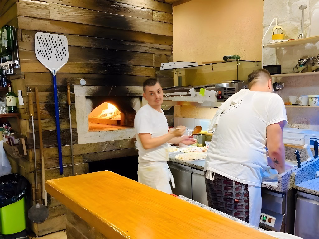 Jure and Andrej preparing pizza at Pizzeria Beštek