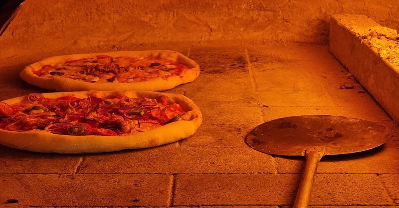 Pizzas baking on moderate flame