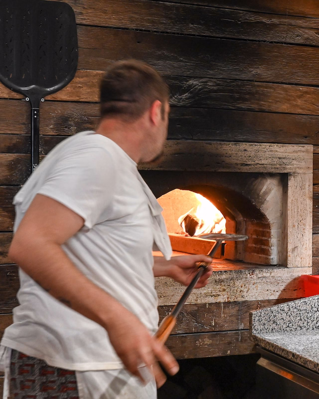 Pizza master in action at Pizzeria Beštek